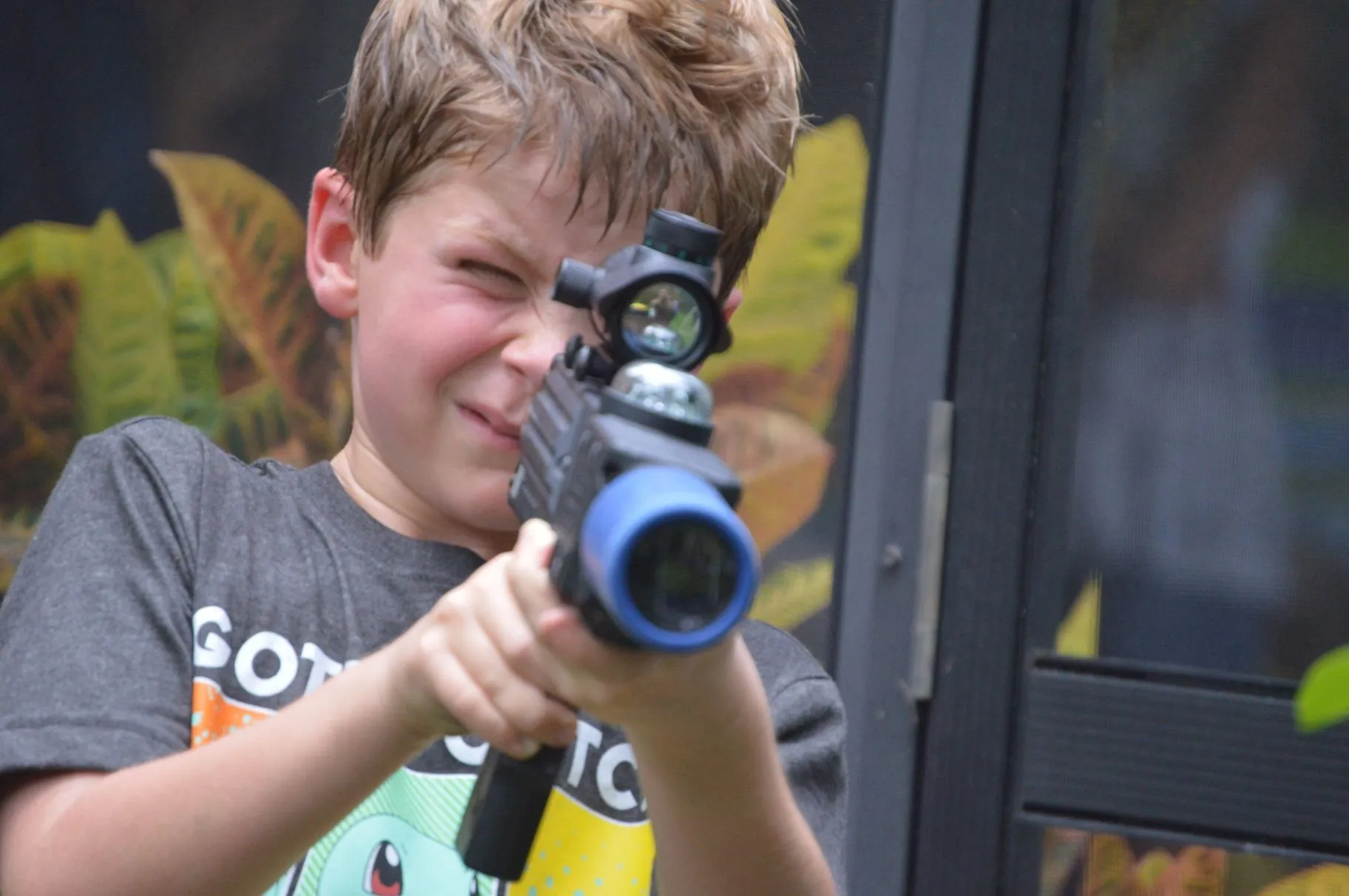 Player aiming a laser tagger during an indoor game