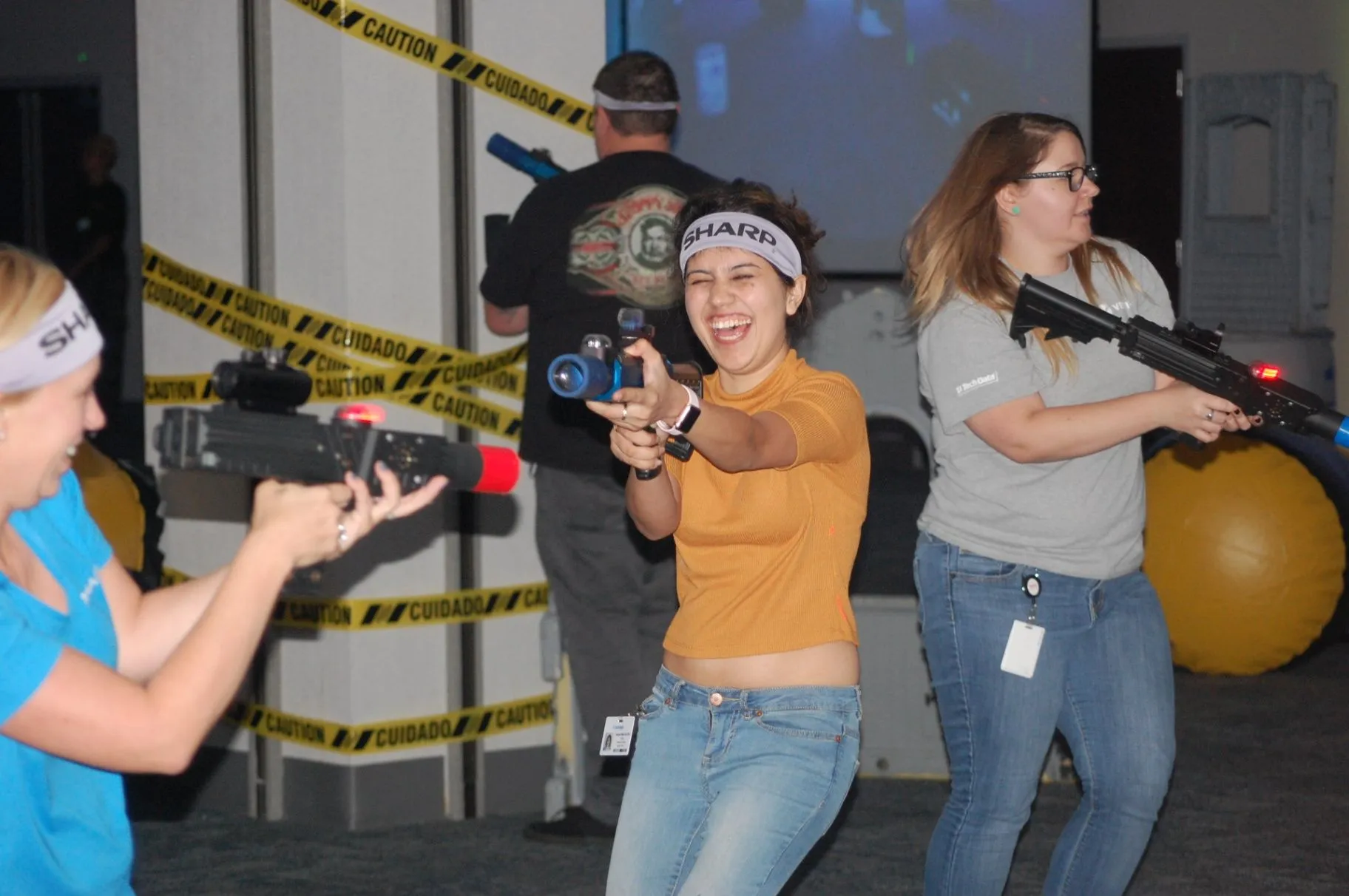 Players using laser tag equipment inside an indoor arena